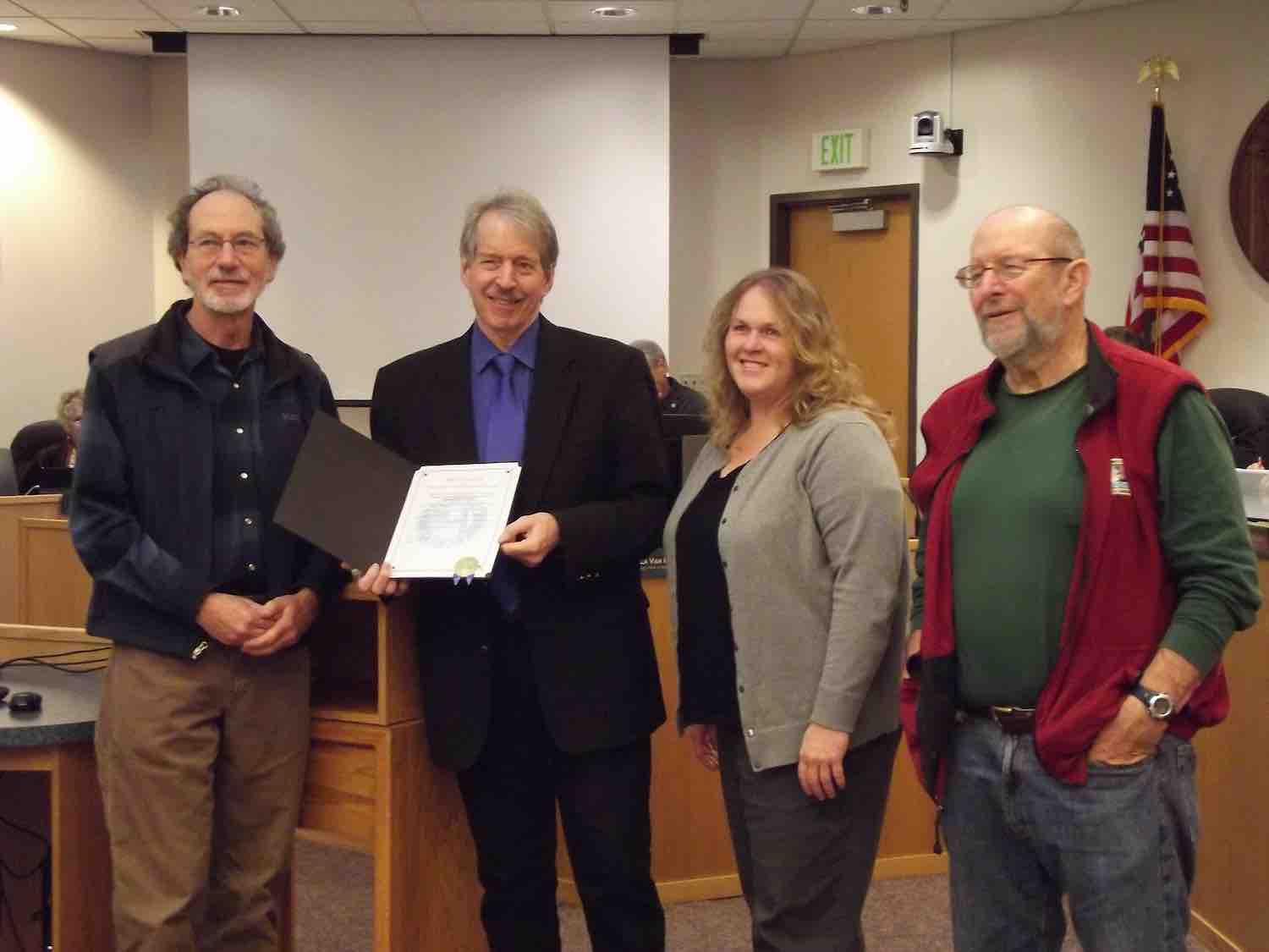 Library Advisory Board Chair Marc Komer, 2nd district Supervisor John McCowen, County Library Director Karen Horner, and LAB Vice Chair Benj Thomas receiving a proclamation celebrating 5 years of Measure A.
