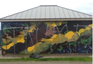 A photo of the defaced Bell Springs mural provided by Andrew Thomson on Redheaded Blackbelt.