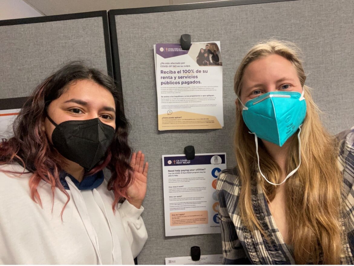 Smiling NCO staffers wearing masks in the office