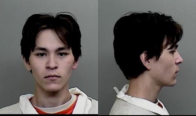 Mugshot of young man in jailhouse uniform.