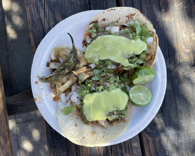 A plate with two tacos on it. 