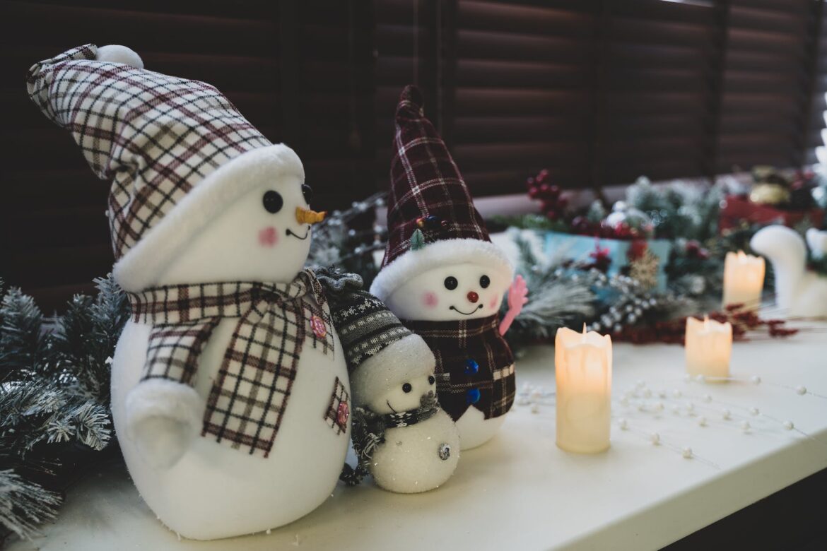 snowmen figures and candles on windowsill